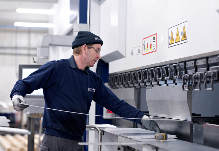 Photography services - a worker handling metal sheeting